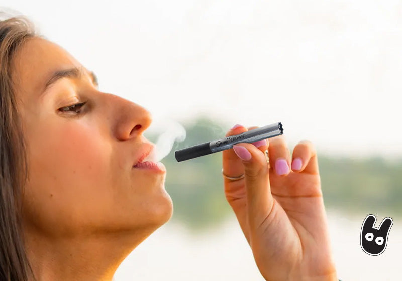 A woman smoking a one-hitter pipe