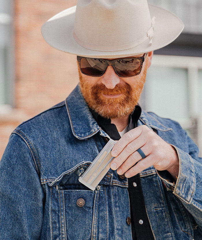 man holding joint case with 3 pre rolled