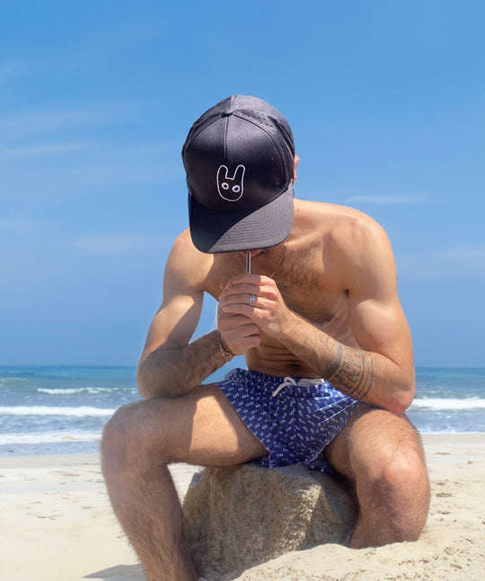 Smosi hat on a guy at the beach