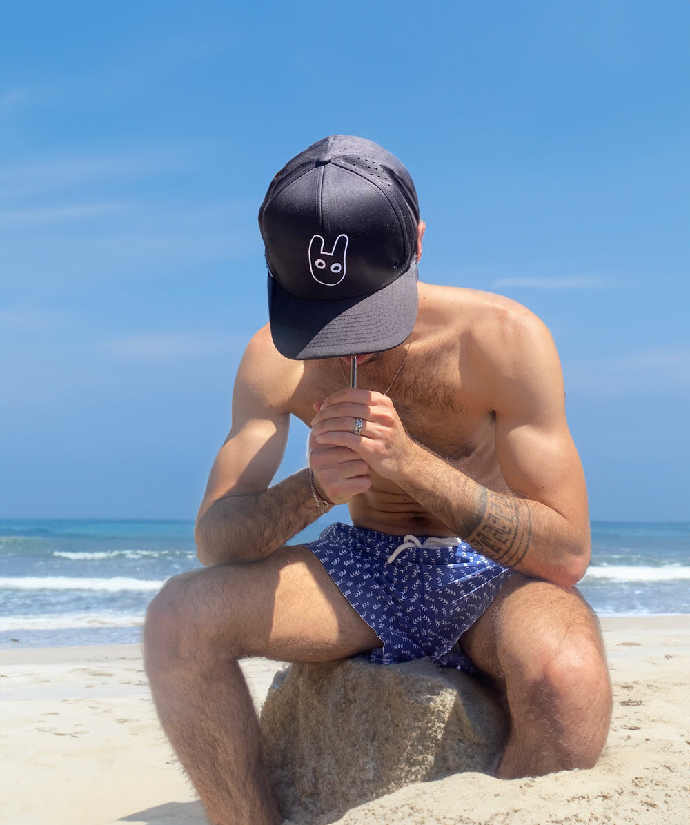 Smosi hat on a guy at the beach
