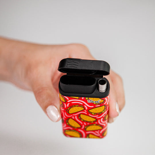 hand holding a open Smosi Original dugout with a one-hitter pipe-taco pattern